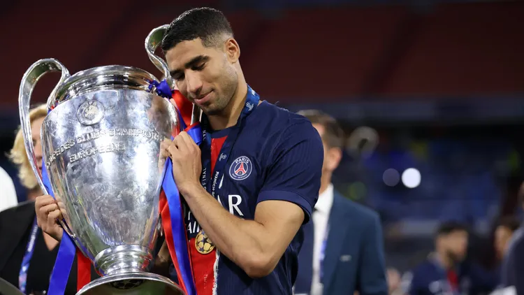 /images/p/a/r/paris-saint-germain-v-fc-internazionale-milano-uefa-champions-league-final-2025-achraf-hakimi-of-paris-saint-germain-fc-celebrates-winning-the-uefa-champions-league-with-the-trophy-at-the-end-the-uefa-champions-league-final-2025-match-between-paris-saint-germain-fc-and-fc-internazionale-milano-at-munich-football-arena-on-may-31-2025-in-munich-germany-munich-munich-football-arena-germany-copyright-xmarcoxcanonieroxjpg_1749060253096.jpg